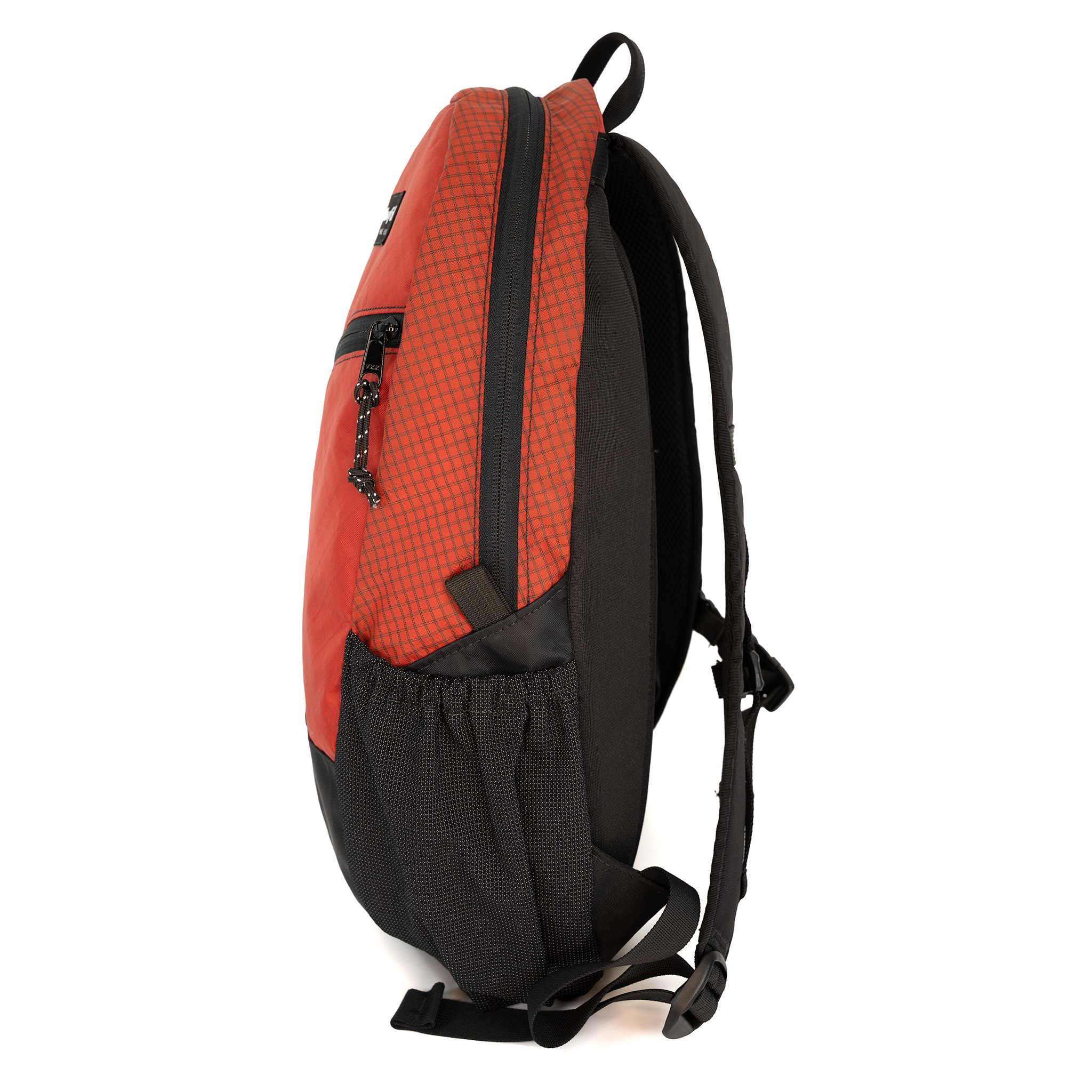 A red and black backpack shown from a side profile view against a plain white background.